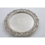 A LATE VICTORIAN ENGRAVED SALVER of shaped circular outline with a beaded rim and a chased & pierced