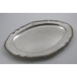 A GEORGE III SHAPED OVAL MEAT DISH with gadrooned border and an engraved coat of arms, by Francis