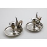 A PAIR OF VICTORIAN PLAIN CIRCULAR CHAMBERSTICKS with dished bases, conical snuffers and