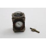 A LATE 19TH CENTURY MOUNTED TORTOISESHELL CARRIAGE TIME PIECE with floral mounts and ball feet,