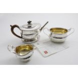 A GEORGE III TEA POT, SUGAR BASIN, MILK JUG & TEA POT STAND (with inset wooden base), each of a