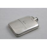 A GEORGE V SLIM RECTANGULAR SPIRIT FLASK with rounded corners, a hinged, twist-open cover and pull-