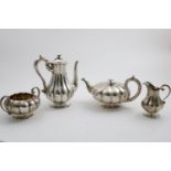AN EARLY VICTORIAN FOUR-PIECE TEA & COFFEE SERVICE of melon-fluted form on polyfoil bases, with S-