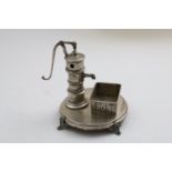 A 19TH CENTURY GERMAN NOVELTY SMOKER'S COMPENDIUM in the form of a water pump and trough on a