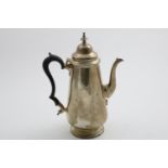 A GEORGE V COFFEE POT of tapering form with a tucked-in base, a domed cover, knop finial and a