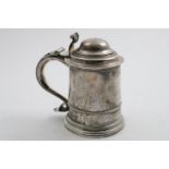 A GEORGE I / II TANKARD of tapering cylindrical form with a skirted base, a domed cover and a