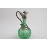 AN EARLY VICTORIAN MOUNTED CUT-GLASS CLARET JUG with a vivid light green coloured, baluster body and