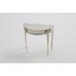 A GEORGE V DRESSING TABLE JEWEL BOX in the form of a demi-lune side table, decorated in relief on