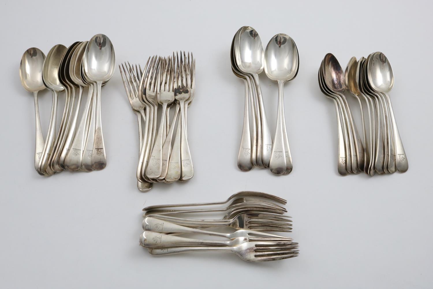 A GEORGE V PART-SERVICE OF OLD ENGLISH PATTERN FLATWARE:- Twelve table spoons, six slightly larger