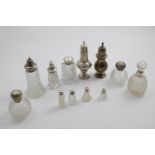 A QUANTITY OF TEN VARIOUS MOUNTED CUT-GLASS BOTTLES/CASTERS and two sugar casters; the larger one 7"