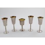 A SET OF FOUR ELIZABETH II GOBLETS with bark-textured stems and flaring bowls with gilt interiors,