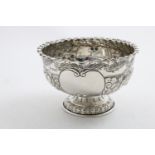 A LATE VICTORIAN EMBOSSED ROSE BOWL with a crimped rim and two vacant cartouches, by W. Gibson and