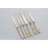 A SET OF SIX GEORGE III / IV DESSERT KNIVES with mother of pearl handles and reeded ferrules, by