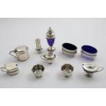 MISCELLANEOUS CONDIMENTS:- A William IV mustard pot, a pair of George V pierced oval salts, an