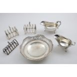 A GEORGE V PIERCED CIRCULAR FRUIT DISH by E. Viner, Sheffield 1931, two sauceboats, and three