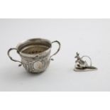 A LATE VICTORIAN PORRINGER with embossed decoration, twin s-scroll handles and a vacant oval