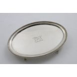 A GEORGE III NORTH COUNTRY PROVINCIAL TEA POT STAND oval with bead borders and ball & claw feet,