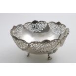 A LATE VICTORIAN FRUIT DISH pierced all around the sides with floral and bird decoration, on three