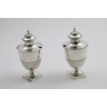 A PAIR OF GEORGE III SUGAR VASES with part-fluted decoration, bead borders and square pedestal