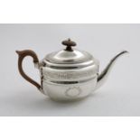 A GEORGE III ENGRAVED OVAL TEA POT with two vacant wreath cartouches, Greek-key work around the