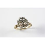 A VICTORIAN DIAMOND AND PEARL DOUBLE HEART RING mounted with two half pearls within a surround of