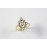 A DIAMOND CLUSTER RING mounted with nine circular collet set diamonds in gold. Size L