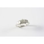 A DIAMOND SOLITAIRE RING the old circular-cut diamond is set with two baguette-cut diamonds to