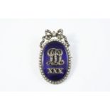 A GEORGIAN DIAMOND AND BLUE ENAMEL BROOCH the blue enamel centre with embossed diamond set initial