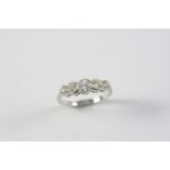 A DIAMOND FIVE STONE RING the five graduated circular-cut diamonds are collet set in platinum.