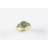 AN EMERALD AND DIAMOND CLUSTER RING the circular-cut emerald is set within a surround of circular-