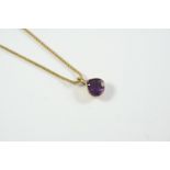AN AMETHYST AND GOLD PENDANT the pear-shaped amethyst is set in 9ct gold, on a 9ct gold neckchain,
