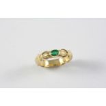 AN EMERALD AND GOLD RING BY TIFFANY & CO. the yellow gold shank with 'Tiffany kiss' decoration and