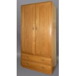 ERCOL WARDROBE a large light elm wardrobe, the top section with two doors to reveal a shelf and