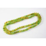 A SINGLE ROW UNIFORM JADE BEAD NECKLACE the jade beads measure approximately 8.2mm, 72cm long