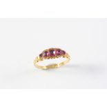 A PINK SAPPHIRE FIVE STONE RING the five graduated oval-shaped pink sapphires are set in 18ct