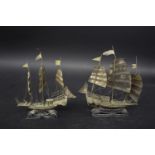 TWO CHINESE MODEL JUNKS probably silver, the masted boats mounted on wooden stands. With Chinese