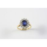 A SAPPHIRE AND DIAMOND CLUSTER RING the oval-shaped sapphire is set within a surround of fourteen