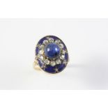 A SAPPHIRE, DIAMOND AND ENAMEL CLUSTER RING the oval-shaped cabochon sapphire is set within a