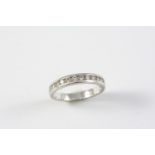 A DIAMOND HALF HOOP RING set with fourteen circular-cut diamonds in 18ct white gold. Size M 1/2