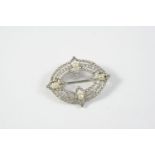 AN EDWARDIAN DIAMOND AND PEARL BROOCH the oval openwork design is mounted with old-cut and rose-