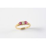 A RUBY AND DIAMOND THREE STONE RING the cushion-shaped diamond is set with two circular-cut rubies