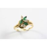 AN EMERALD AND DIAMOND RING set with three marquise-cut emeralds and three marquise-cut diamonds, in