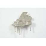 A DIAMOND GRAND PIANO BROOCH set overall with circular-cut diamonds, in 18ct white gold, 4cm wide