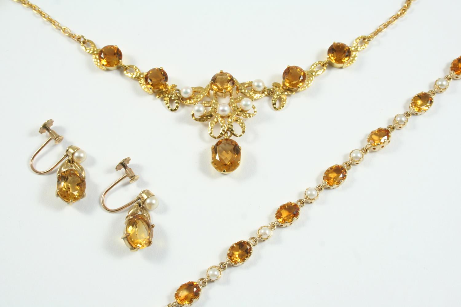 A CITRINE AND CULTURED PEARL NECKLACE mounted with circular-cut citrines and cultured pearls, in 9ct