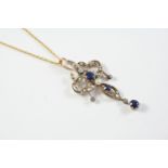 AN EDWARDIAN SAPPHIRE AND DIAMOND PENDANT the openwork foliate mount is set with three oval