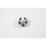 A VICTORIAN SAPPHIRE AND DIAMOND HORSESHOE BROOCH mounted with four old cushion-shaped diamonds