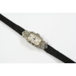 A LADY'S DIAMOND COCKTAIL WRISTWATCH the rectangular-shaped dial with Arabic numerals, with