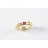 A RUBY AND GOLD RING BY TIFFANY & CO. the yellow gold mount with 'Tiffany kiss' decoration and set