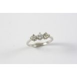 A DIAMOND THREE STONE RING set with three circular-cut diamonds, in platinum. Size L