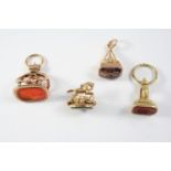 FOUR ASSORTED GOLD SEALS one with a carnelian matrix engraved with a coat of arms, 3.5cm high, one